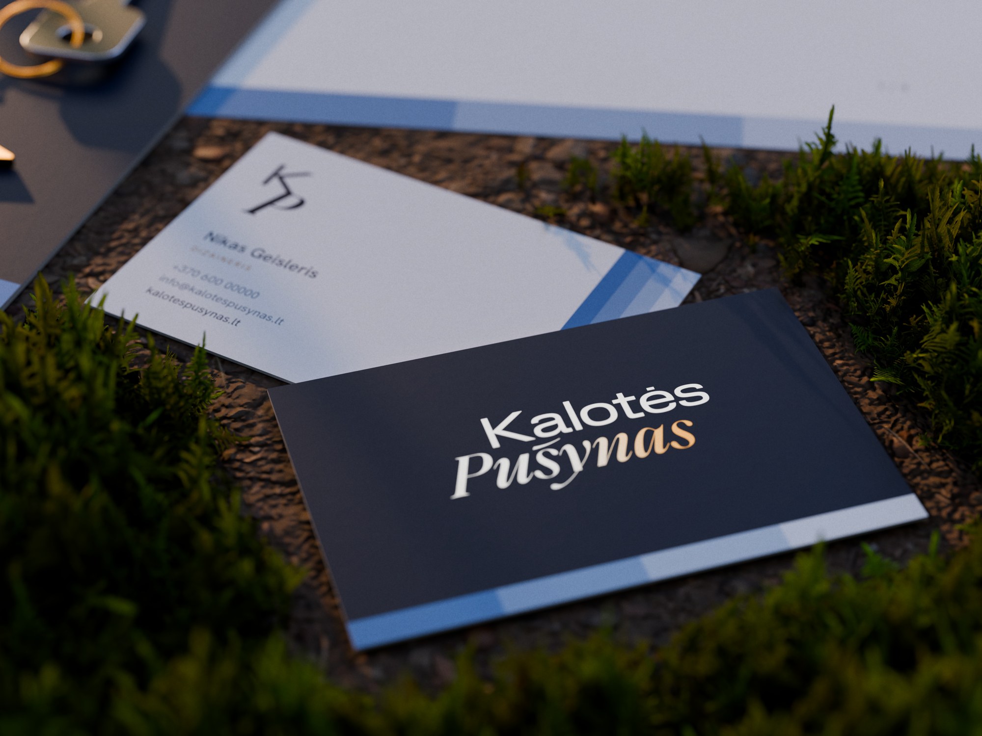 Business card front in deep blue with silver to gold foil over the four steps, and the cream back with the KP monogram and the steps along its side