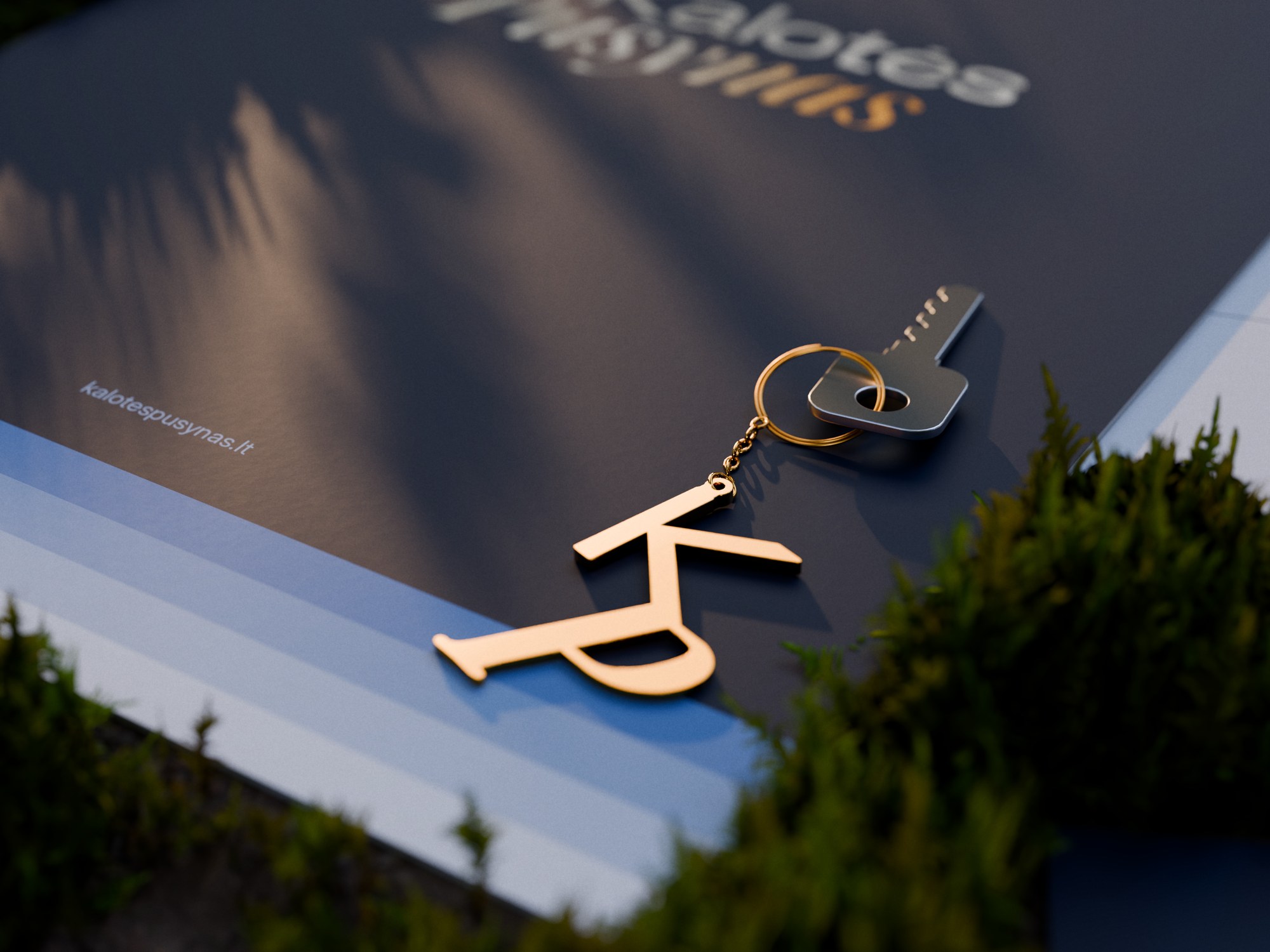 Gold KP monogram keychain on a small chain, with the house key on its ring